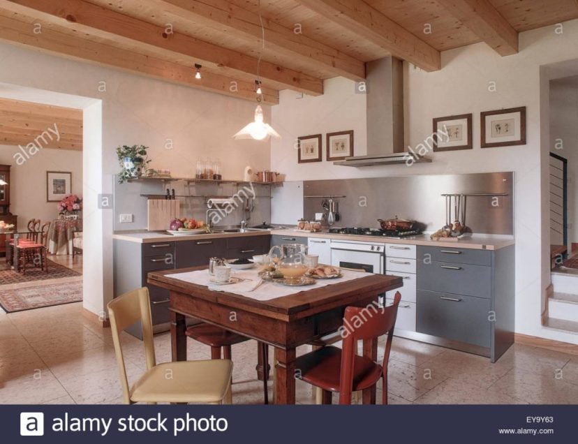 foreground of table laid in the rustic kitchen with marble