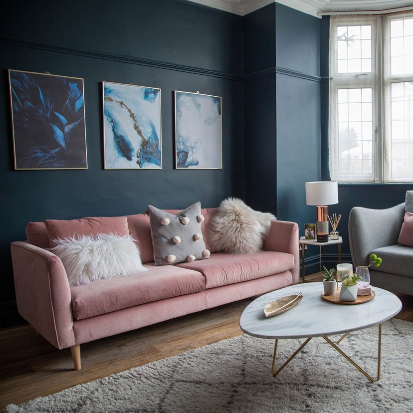 blue and gold living room living room makeover with dark blue walls pink sofa and